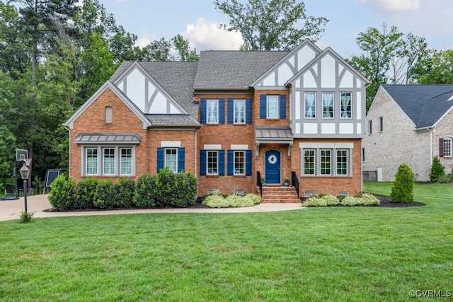 13518 Kelham Rd, Midlothian, VA 23113 - english style home featuring brick siding, a front lawn, a shingled roof, and stucco siding