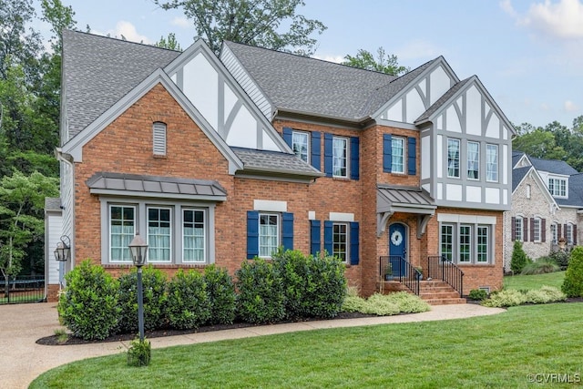 13518 Kelham Rd, Midlothian, VA 23113 - tudor-style house with roof with shingles, a front lawn, brick siding, a standing seam roof, and stucco siding