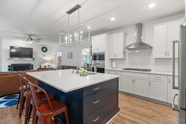13518 Kelham Rd, Midlothian, VA 23113 - kitchen featuring wall chimney exhaust hood, open floor plan, white cabinetry, a ceiling fan, and recessed lighting
