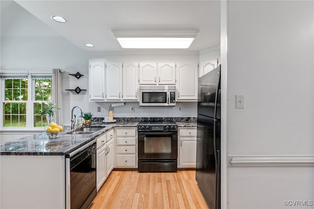 1424 Laurel Top Dr, Midlothian, VA 23114 - kitchen featuring black appliances, white cabinets, light wood-type flooring, tasteful backsplash, and dark stone countertops