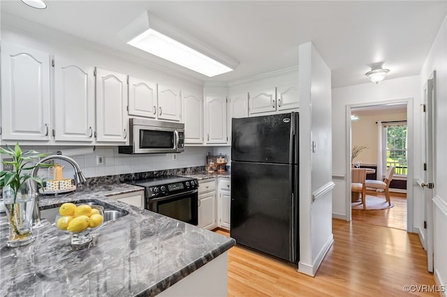 1424 Laurel Top Dr, Midlothian, VA 23114 - kitchen with black appliances, light wood-style floors, white cabinetry, dark stone countertops, and decorative backsplash