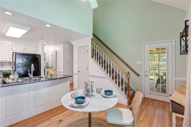 1424 Laurel Top Dr, Midlothian, VA 23114 - dining space featuring light wood-style floors, stairway, recessed lighting, and a high ceiling