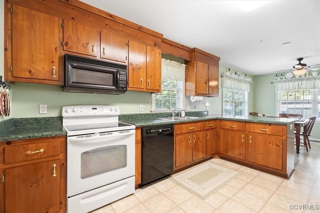 2551 Walkers Ridge Cir, Powhatan, VA 23139 - kitchen with black appliances, a peninsula, brown cabinetry, and dark countertops