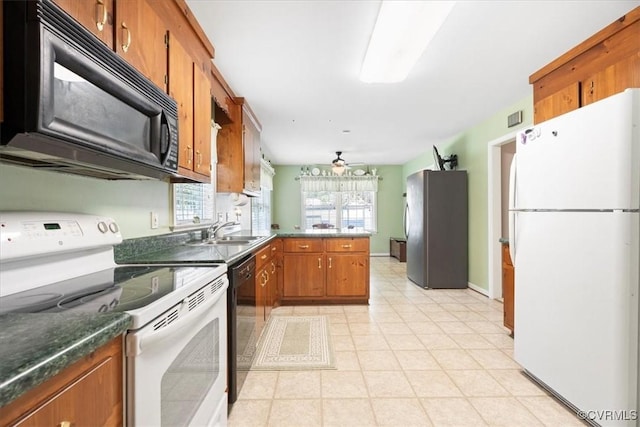 2551 Walkers Ridge Cir, Powhatan, VA 23139 - kitchen featuring black appliances, a peninsula, brown cabinets, and dark countertops