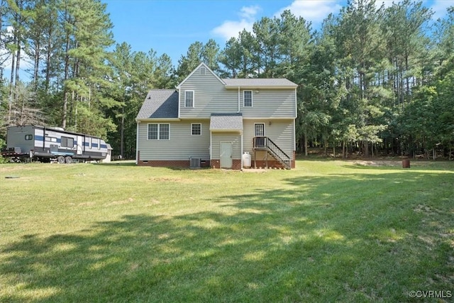 2551 Walkers Ridge Cir, Powhatan, VA 23139 - back of property featuring a lawn, crawl space, view of wooded area, and roof with shingles