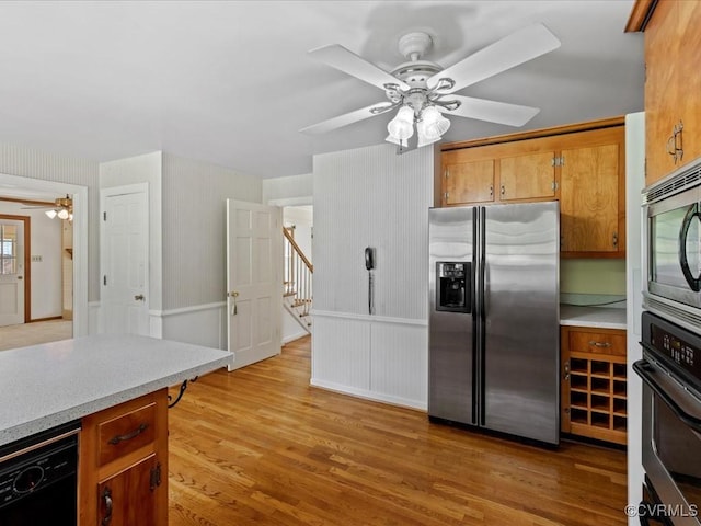 2340 Scarsborough Dr, North Chesterfield, VA 23235 - kitchen featuring appliances with stainless steel finishes, ceiling fan, light countertops, light wood-style flooring, and brown cabinetry