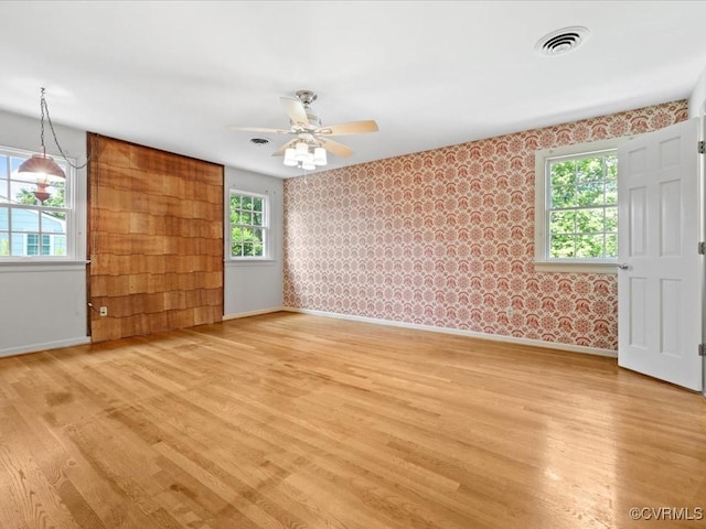 2340 Scarsborough Dr, North Chesterfield, VA 23235 - empty room featuring light wood-style flooring, plenty of natural light, wallpapered walls, and ceiling fan