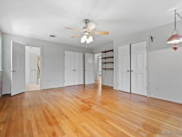 2340 Scarsborough Dr, North Chesterfield, VA 23235 - unfurnished bedroom with multiple closets, light wood-style flooring, and a ceiling fan