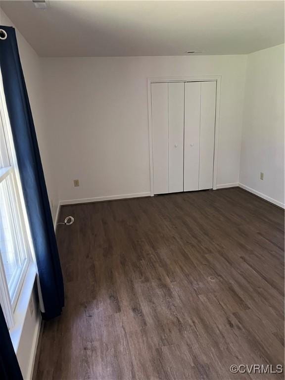 10904 Robin Spring Ln, Glen Allen, VA 23060 - unfurnished bedroom with dark wood-style flooring and a closet