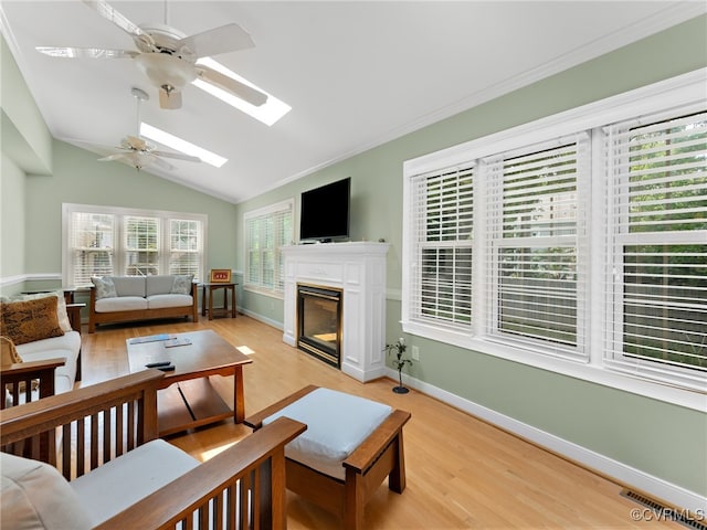 2730 Dalkeith Dr, Henrico, VA 23233 - living room with ceiling fan, a skylight, light wood-style floors, lofted ceiling, and a glass covered fireplace