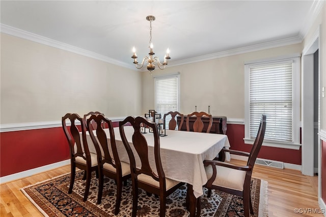 2730 Dalkeith Dr, Henrico, VA 23233 - dining space featuring a chandelier, light wood-style flooring, and crown molding