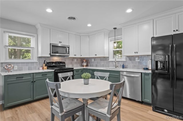 611 Queensway Rd, North Chesterfield, VA 23236 - kitchen featuring black appliances, green cabinetry, light countertops, light wood-type flooring, and white cabinets