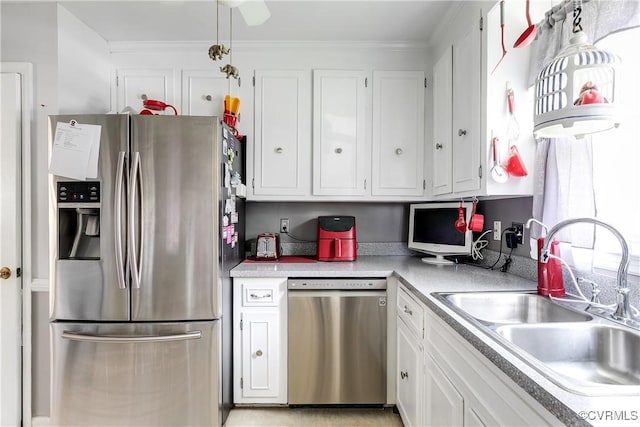 4601 Helena Cir, Petersburg, VA 23803 - kitchen featuring stainless steel appliances, light countertops, white cabinets, and ornamental molding