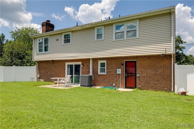 4601 Helena Cir, Petersburg, VA 23803 - rear view of house with a chimney, a fenced backyard, brick siding, and a patio area