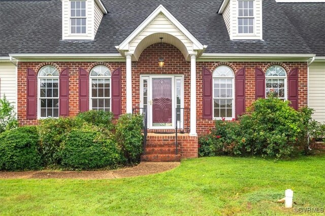 17220 Dawn Ct, Amelia Courthouse, VA 23002 - view of exterior entry with brick siding, a yard, and roof with shingles