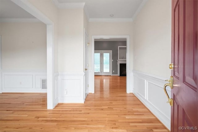 17220 Dawn Ct, Amelia Courthouse, VA 23002 - entryway with light wood-type flooring, a fireplace, a decorative wall, wainscoting, and ornamental molding