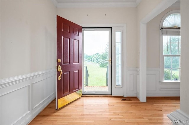 17220 Dawn Ct, Amelia Courthouse, VA 23002 - foyer with a decorative wall, a wainscoted wall, light wood-type flooring, and crown molding