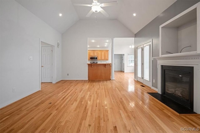 17220 Dawn Ct, Amelia Courthouse, VA 23002 - unfurnished living room with a ceiling fan, high vaulted ceiling, a glass covered fireplace, light wood-type flooring, and recessed lighting