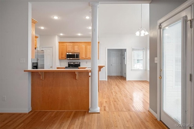 17220 Dawn Ct, Amelia Courthouse, VA 23002 - kitchen featuring appliances with stainless steel finishes, light wood-style floors, a kitchen breakfast bar, light countertops, and a peninsula