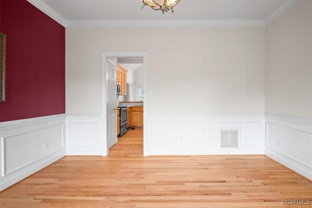 17220 Dawn Ct, Amelia Courthouse, VA 23002 - unfurnished room with light wood finished floors, ornamental molding, wainscoting, and a chandelier