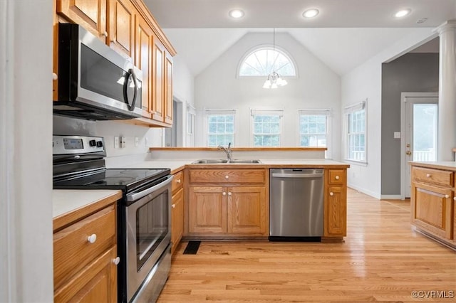 17220 Dawn Ct, Amelia Courthouse, VA 23002 - kitchen with stainless steel appliances, light wood-type flooring, vaulted ceiling, a peninsula, and a chandelier