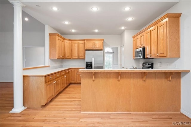 17220 Dawn Ct, Amelia Courthouse, VA 23002 - kitchen with stainless steel appliances, a peninsula, light wood finished floors, light countertops, and recessed lighting