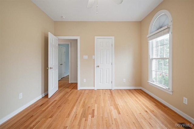 17220 Dawn Ct, Amelia Courthouse, VA 23002 - unfurnished bedroom with light wood-style floors, multiple windows, a ceiling fan, and a closet