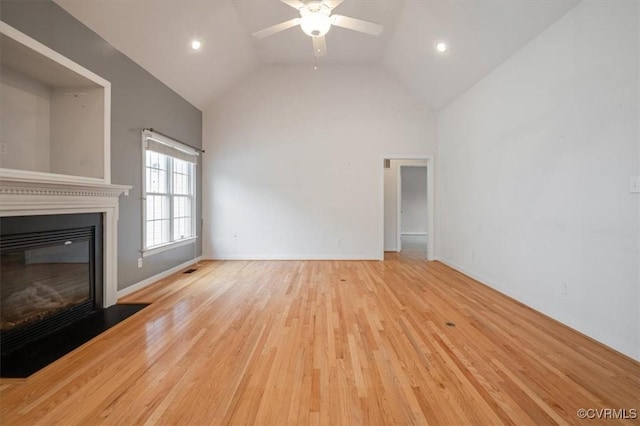17220 Dawn Ct, Amelia Courthouse, VA 23002 - unfurnished living room with ceiling fan, high vaulted ceiling, a glass covered fireplace, wood finished floors, and recessed lighting