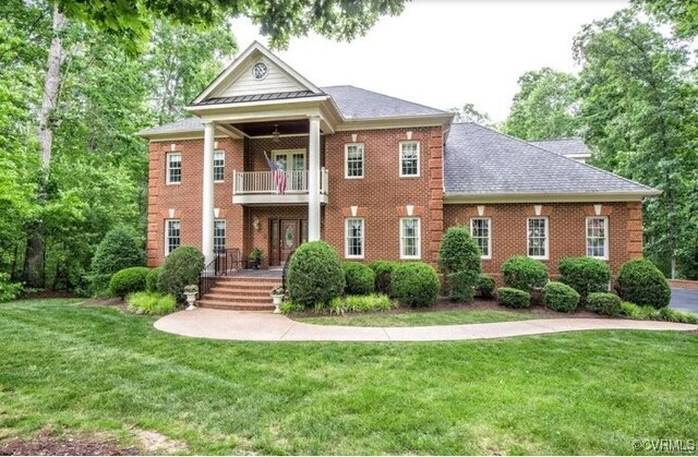 1638 Fallen Timber Trl, Powhatan, VA 23139 - view of front of property with a balcony, a front yard, and brick siding