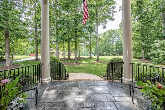 1638 Fallen Timber Trl, Powhatan, VA 23139 - covered porch featuring a lawn and view of wooded area