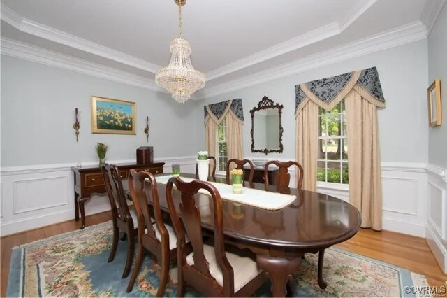 1638 Fallen Timber Trl, Powhatan, VA 23139 - dining area featuring light wood-style floors, a chandelier, ornamental molding, a decorative wall, and wainscoting