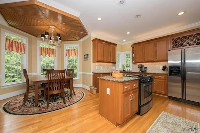 1638 Fallen Timber Trl, Powhatan, VA 23139 - kitchen featuring appliances with stainless steel finishes, light wood finished floors, a chandelier, light stone counters, and brown cabinets