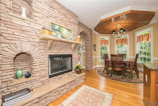 1638 Fallen Timber Trl, Powhatan, VA 23139 - living room featuring wood finished floors, a chandelier, and a fireplace