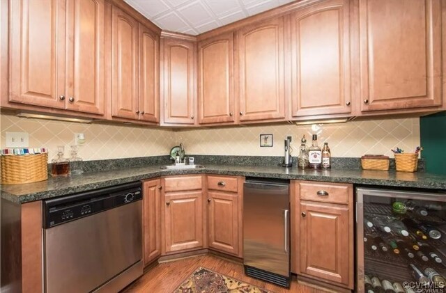 1638 Fallen Timber Trl, Powhatan, VA 23139 - kitchen with dishwasher, beverage cooler, dark countertops, light wood-type flooring, and backsplash