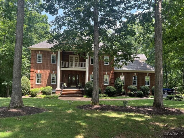 1638 Fallen Timber Trl, Powhatan, VA 23139 - neoclassical / greek revival house with a balcony, a front yard, and brick siding
