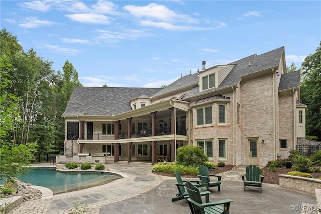 923 Merchant Lee Pl, Manakin Sabot, VA 23103 - back of property featuring a balcony, a patio, brick siding, an outdoor pool, and a sunroom