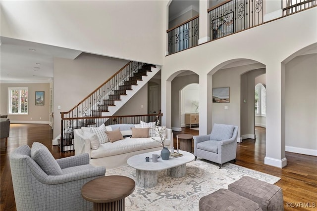 923 Merchant Lee Pl, Manakin Sabot, VA 23103 - living area with stairs, wood finished floors, arched walkways, a high ceiling, and ornamental molding