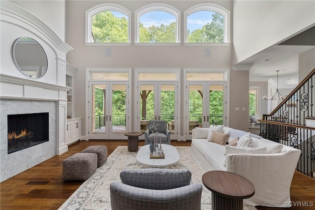 923 Merchant Lee Pl, Manakin Sabot, VA 23103 - living room with french doors, a towering ceiling, dark wood-style flooring, and healthy amount of natural light