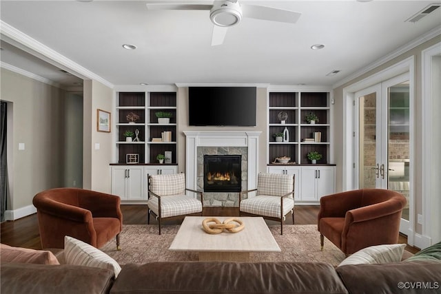923 Merchant Lee Pl, Manakin Sabot, VA 23103 - living room with wood finished floors, a glass covered fireplace, a ceiling fan, crown molding, and built in shelves