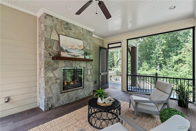 923 Merchant Lee Pl, Manakin Sabot, VA 23103 - living area with crown molding, a ceiling fan, wood finished floors, wood walls, and a stone fireplace