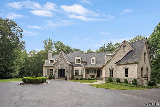 923 Merchant Lee Pl, Manakin Sabot, VA 23103 - french country style house featuring stone siding, a chimney, and curved driveway