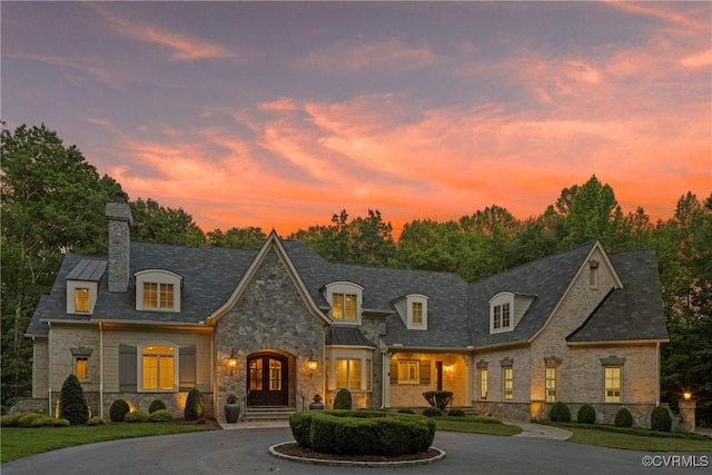 923 Merchant Lee Pl, Manakin Sabot, VA 23103 - french provincial home with stone siding, a chimney, curved driveway, french doors, and a lawn