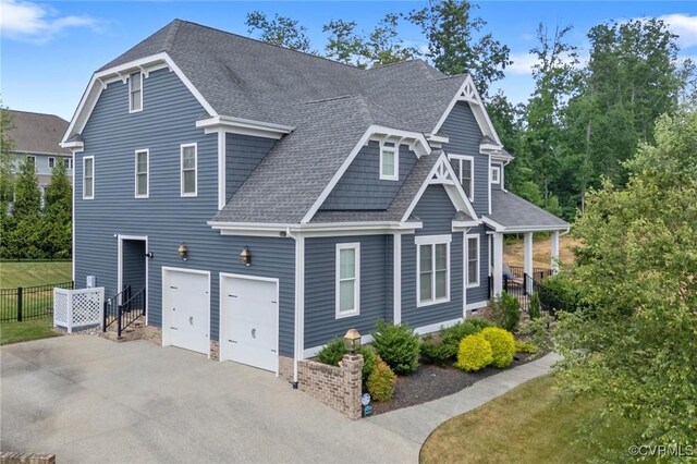 5154 Lake Summer Loop, Moseley, VA 23120 - view of front of house featuring a shingled roof, driveway, a garage, and covered porch