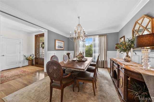 5154 Lake Summer Loop, Moseley, VA 23120 - dining area with a chandelier, ornamental molding, light wood-style floors, wainscoting, and a decorative wall