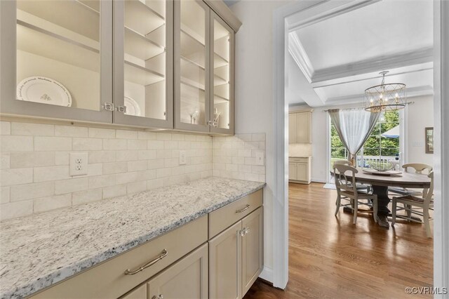 5154 Lake Summer Loop, Moseley, VA 23120 - kitchen with crown molding, dark wood-style floors, light stone countertops, glass insert cabinets, and a chandelier