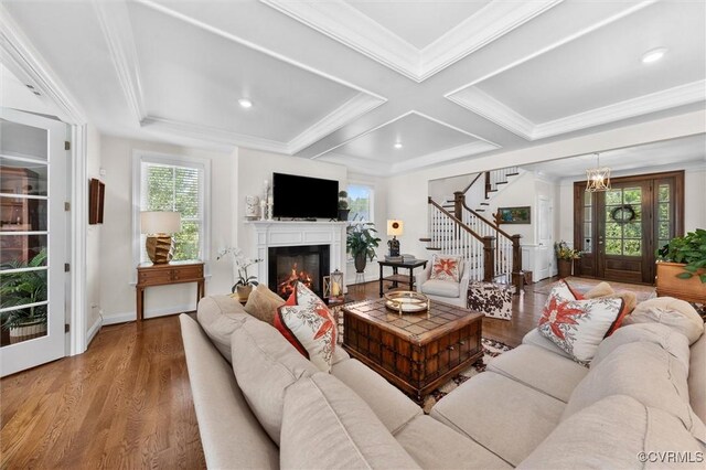 5154 Lake Summer Loop, Moseley, VA 23120 - living room featuring stairs, plenty of natural light, wood finished floors, a glass covered fireplace, and coffered ceiling