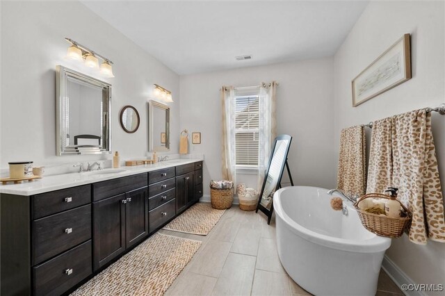 5154 Lake Summer Loop, Moseley, VA 23120 - full bathroom featuring double vanity, a freestanding bath, and tile patterned flooring