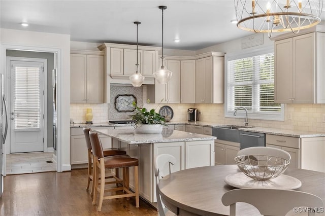 5154 Lake Summer Loop, Moseley, VA 23120 - kitchen with a center island, stainless steel appliances, tasteful backsplash, wood finished floors, and light stone countertops