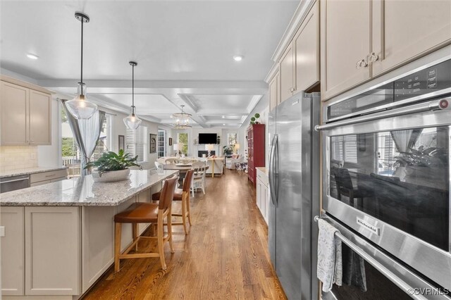 5154 Lake Summer Loop, Moseley, VA 23120 - kitchen with appliances with stainless steel finishes, light wood finished floors, coffered ceiling, open floor plan, and decorative backsplash