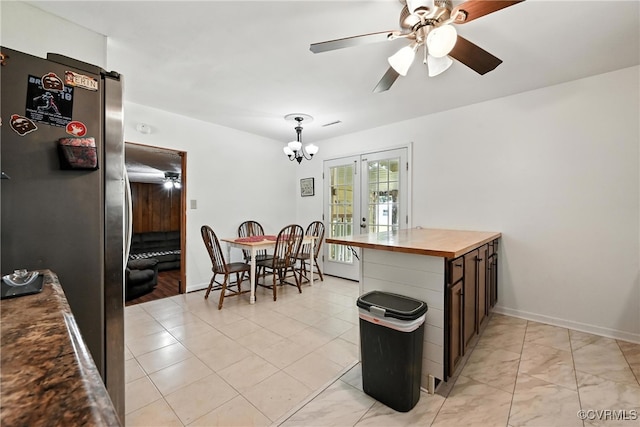 1593 Baxter Rd, Prince George, VA 23875 - kitchen with wooden counters, freestanding refrigerator, a chandelier, a ceiling fan, and decorative light fixtures